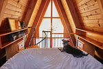 Dog on bed in A-frame house