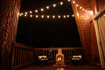 Fireplace and two wicker chairs on verandah of house