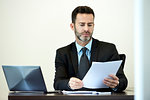 Businessman reading documents in office