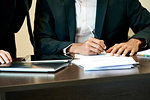 Businessman signing a document in office