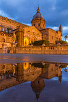 The illuminated Palermo Cathedral (UNESCO World Heritage Site) reflected in a puddle, Palermo, Sicily, Italy, Europe