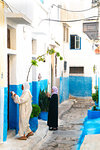 Two woman in local dress at neighbouring front doors, Kasbah des Oudaias, UNESCO World Heritage Site, Rabat, Morocco, North Africa, Africa