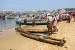 Fishing boats at Vizhinjam beach fish market, near Kovalam, Kerala, India, South Asia