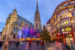 View of St. Stephen's Cathedral, shops and Christmas tree on Stephanplatz at dusk, Vienna, Austria, Europe