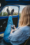 Woman using smartphone inside car