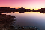 Silhouetted mountain ranges on horizon over water, Cape Town, Western Cape, South Africa