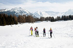 Five teenage girl skiers skiing on snow covered landscape, Tyrol, Styria, Austria