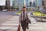 Businessman walking on pedestrian crossing, Milano, Lombardia, Italy