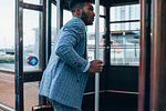Businessman boarding tram in city