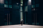 Businessman standing in front of office building, Milano, Lombardia, Italy
