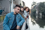 Friends relaxing by river, Milano, Lombardia, Italy