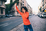 Young man hailing cab in city, Milano, Lombardia, Italy