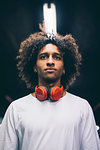 Young man with headphones around neck