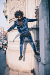 Young man balancing on ledge, Milano, Lombardia, Italy