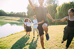 Group of friends having fun by lake