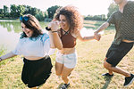 Group of friends having fun by lake