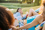 Group of friends relaxing at picnic in park