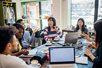 Male and female business team meeting while having working lunch at cafe table