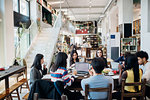 Male and female business team meeting while having working lunch at cafe table