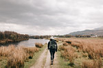 Trekker walking by Loch Lomond, Trossachs National Park, Canada