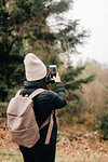 Trekker taking photo, Trossachs National Park, Canada