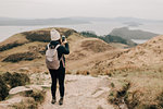 Trekker taking photo of Loch Lomond, Trossachs National Park, Canada