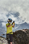 Mountain biker taking photo, Saas-Fee, Valais, Switzerland