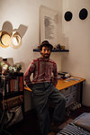 Bearded young man sitting on bedroom table