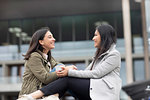 Friends relaxing in front of building