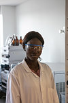 Young female scientist wearing safety glasses in laboratory, portrait