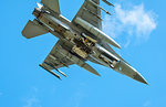 Dutch F-16 fighter plane taking part in NATO exercise Frysian flag, low angle against blue sky, Netherlands