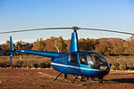 Helicopter and pilot in rural landscape, Cape Town, Western Cape, South Africa