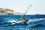 Young man windsurfing ocean waves, Limnos, Khios, Greece