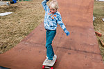 Boy skateboarding on wooden skateboard ramp