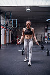 Young woman skipping in gym