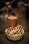 Breakfast wraps and glass of iced coffee on cafe table, shallow focus close up