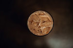 Glass of iced coffee on cafe table, overhead view