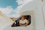 Woman leaning out window of motorhome