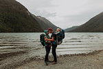 Parents with baby kissing on beach, Queenstown, Canterbury, New Zealand