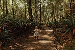 Baby girl exploring forest, Queenstown, Canterbury, New Zealand