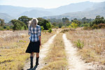 Woman walking on dirt road in Capetown, Soouth Africa