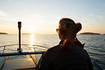 Woman on boat at sunset