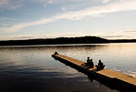 Young woman on the pier of a lake in Dalarna Sweden