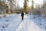 Mature woman walking on snowy road