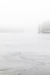 Fog on frozen Stora Skiren lake in Finspang, Sweden