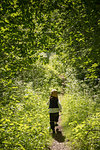 Girl running by trees