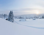 Log cabins covered in snow