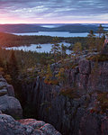 Cliffs and forest by Baltic Sea at sunset in Skuleskogen National Park, Sweden