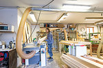 Carpenter holding timber in workshop