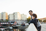 Father and son leaning on city railing